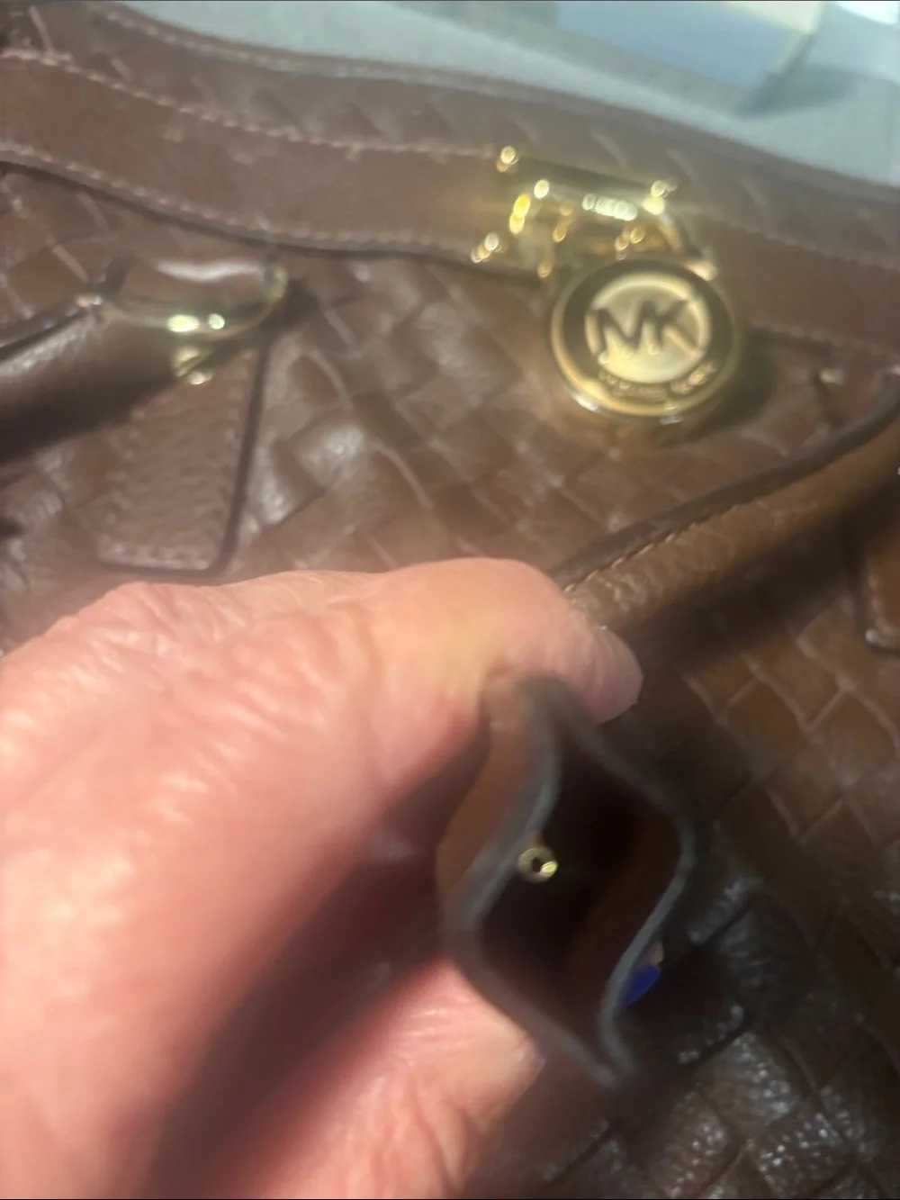 Michael Kors brown leather woven purse with lock and key